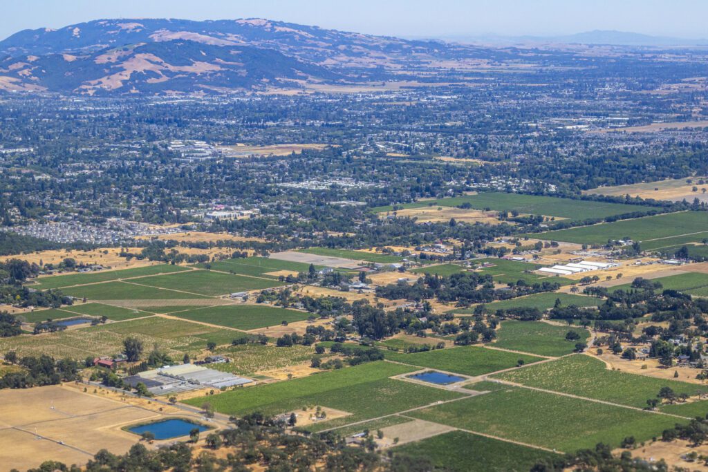 Aerial view of green fields and hills.