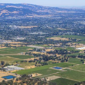 Aerial view of green fields and hills.