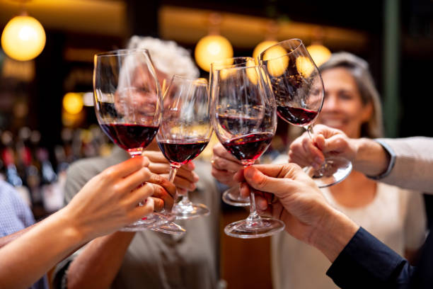 Friends clinking red wine glasses